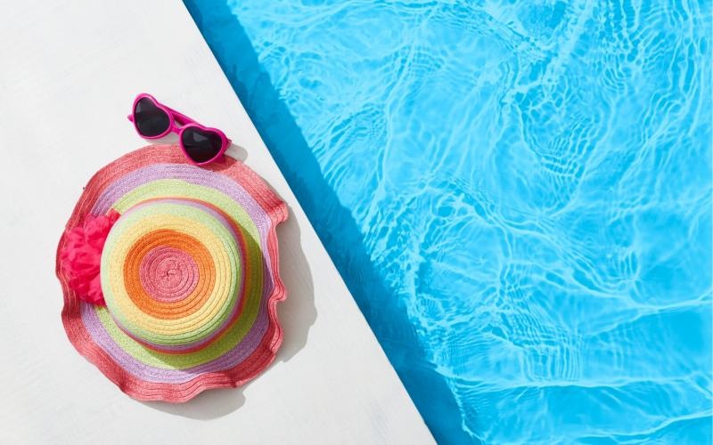 a pool with glasses and a hat