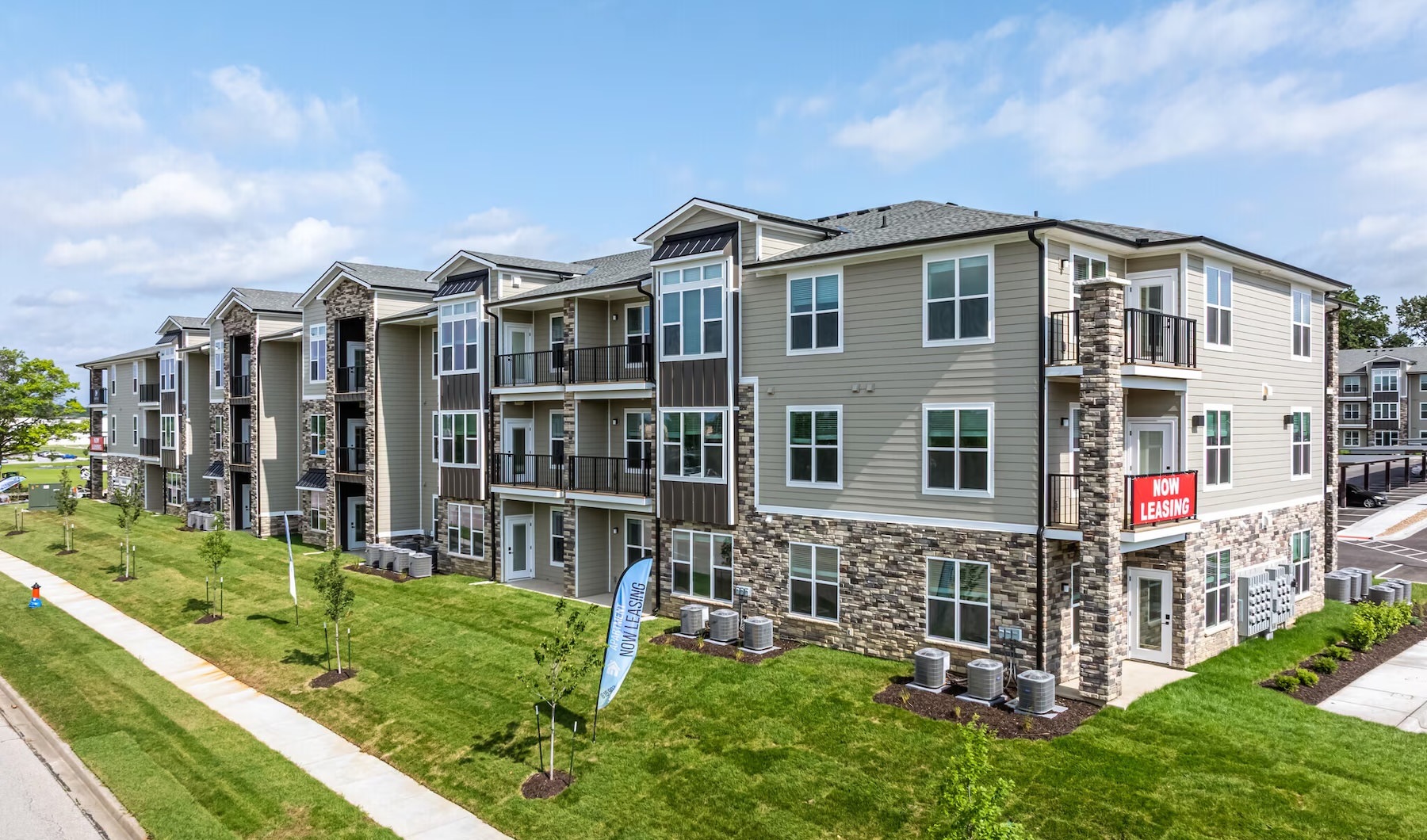 an apartment building with a lawn