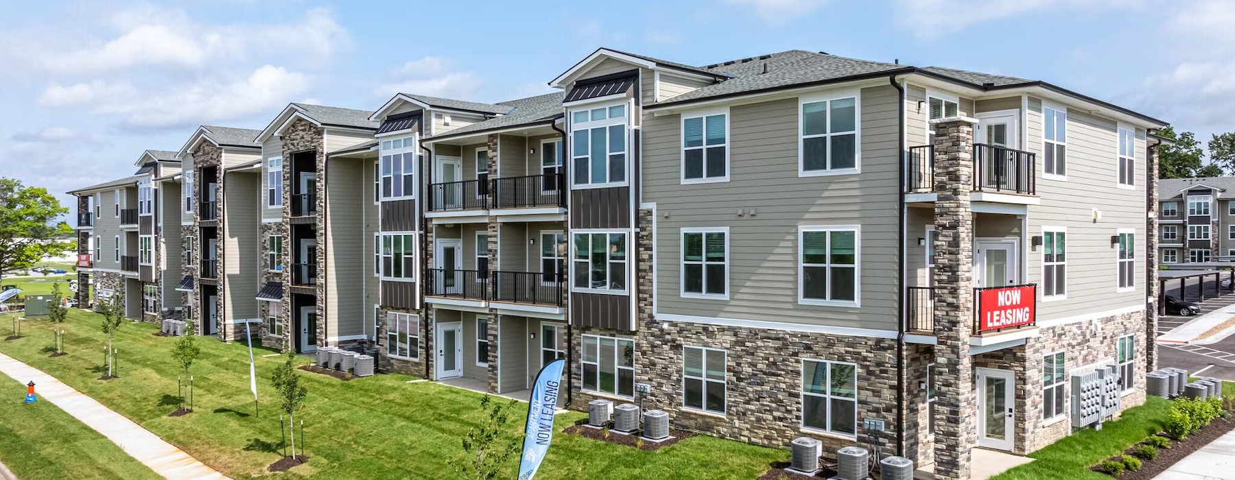 an apartment building with a lawn