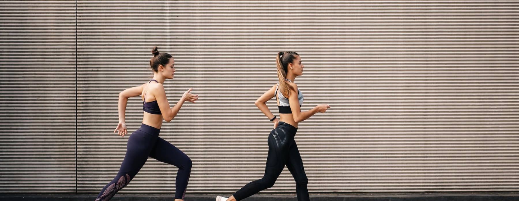 two women running on a street